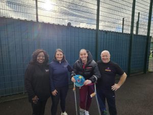 Wales international Soffia Kelly showing her Welsh cap to young players at North Cardiff Cosmos FC.
