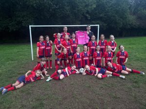 North Cardiff Cosmos Under 10 Girls proudly displaying their Latch charity shirt sponsorship.