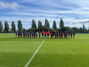 North Cardiff Cosmos Under 7 Girls walking onto the pitch as mascots with Cardiff City FC Women.